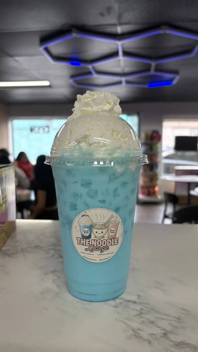 Blue Lagoon dirty soda with a whipped cream top