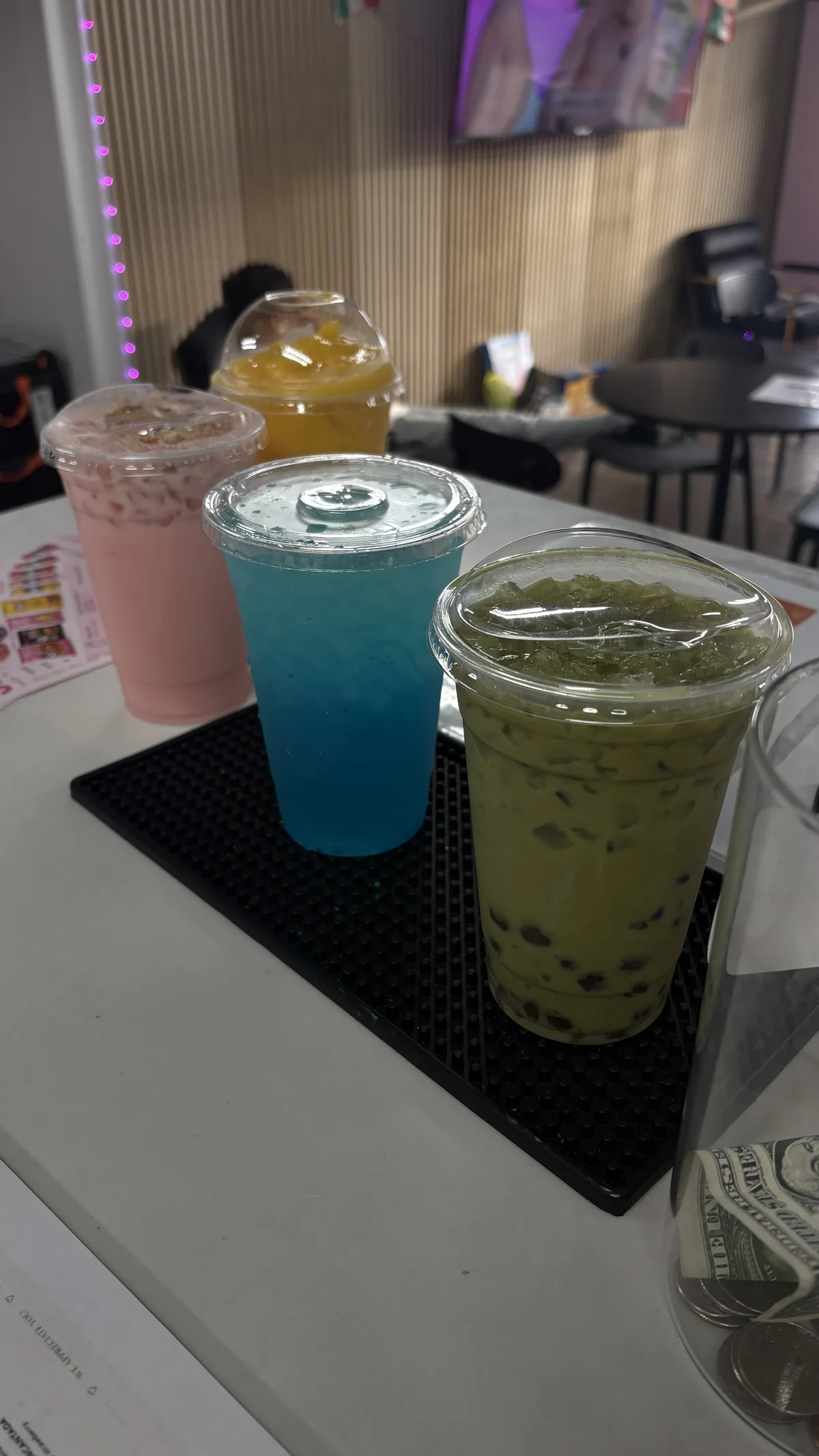 Four signature drinks lined up on the bar: pink creamy Red Bull, mango dome, blue lemonade refresher and matcha boba