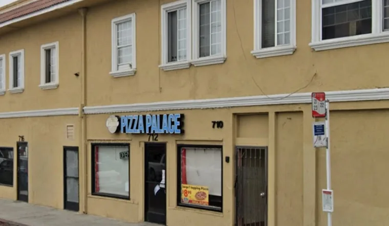 The storefront before, as Pizza Palace