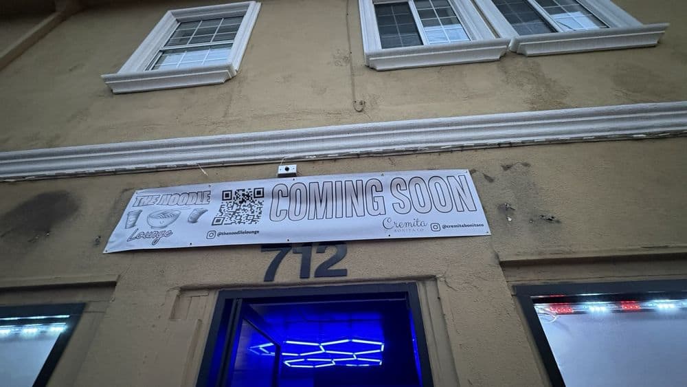 The storefront wrapped in coming-soon signage